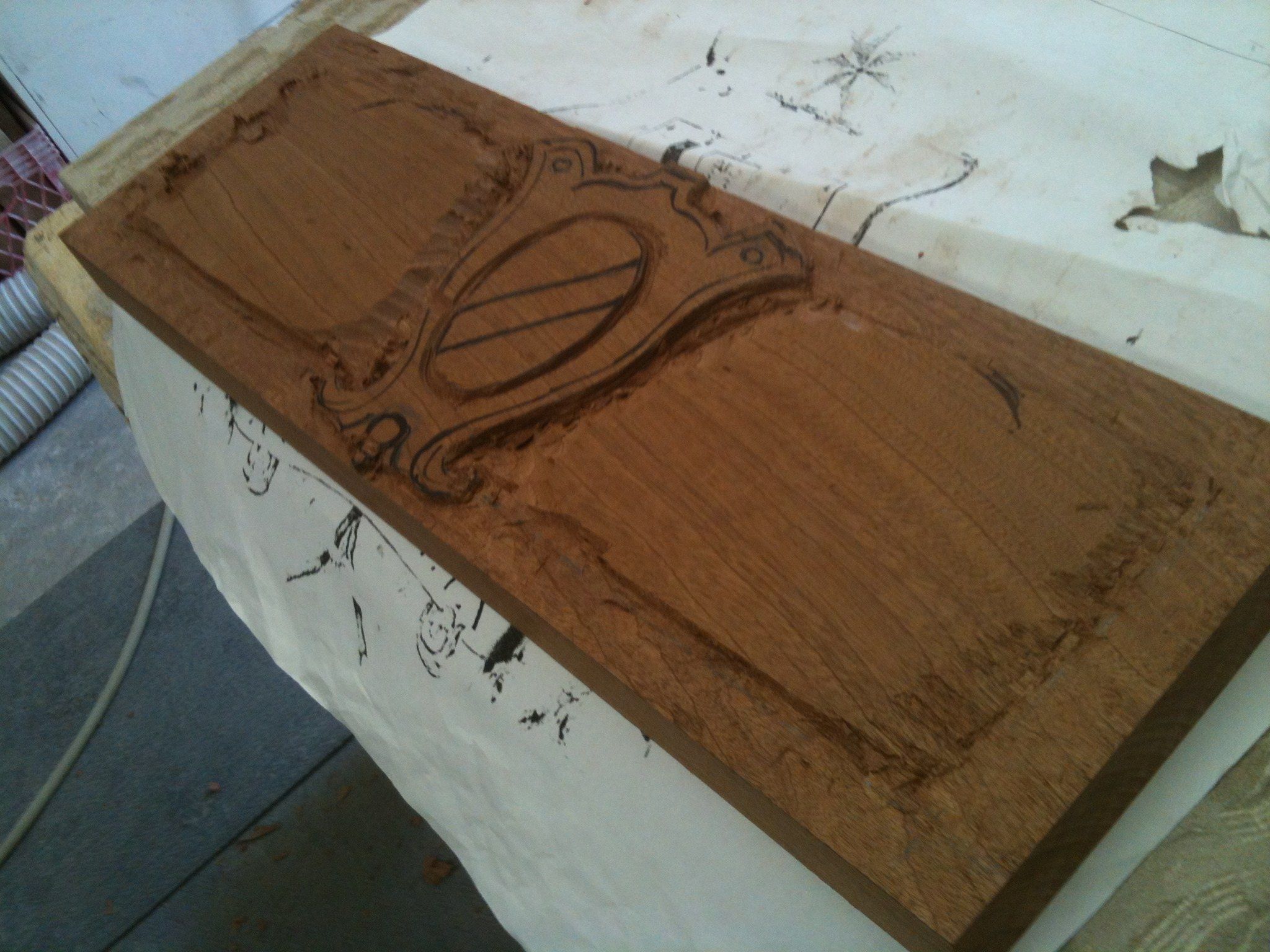 The panel at the start: the cartouche and its frame cut in, the rest of the board still flat.