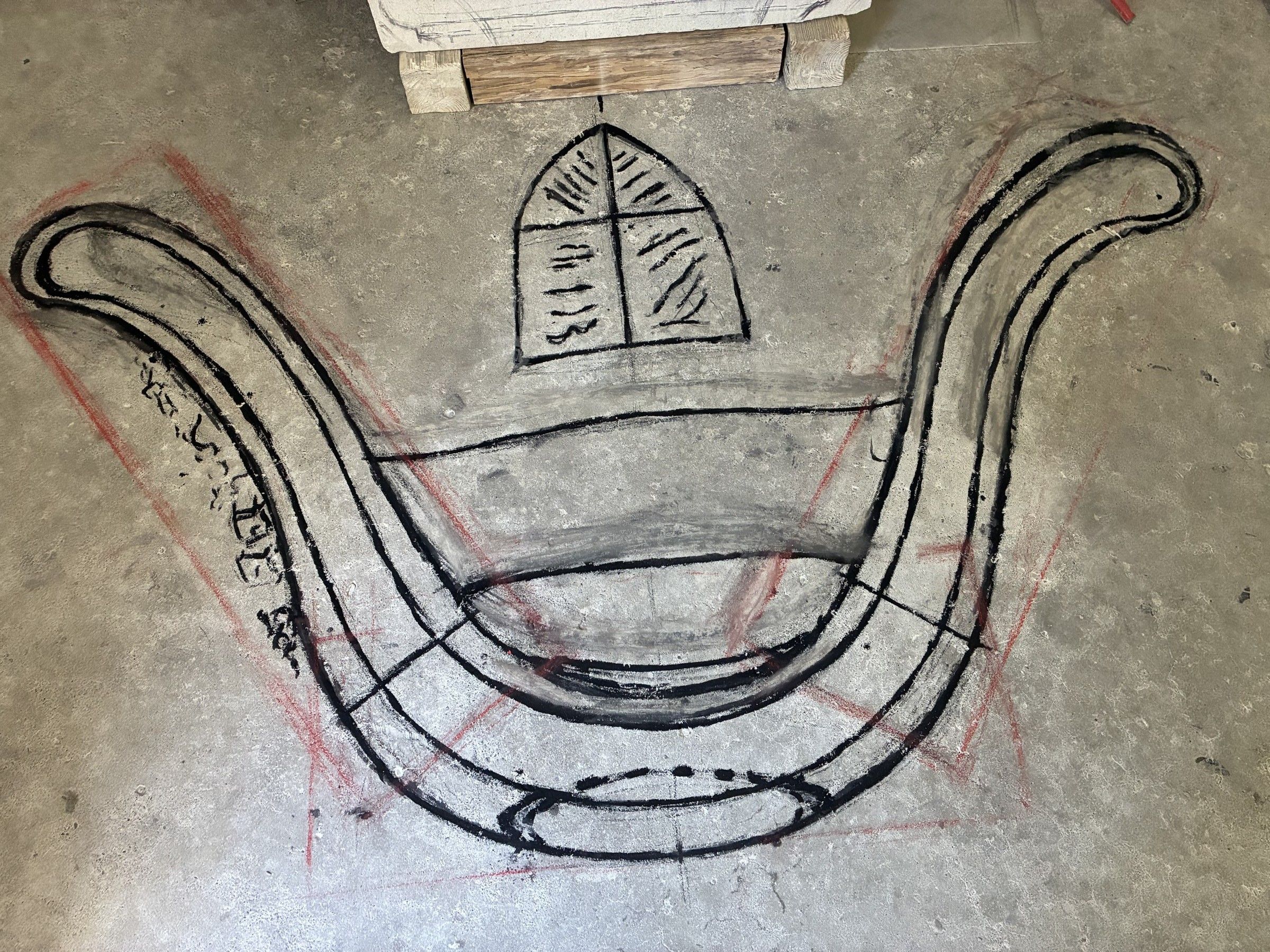 The very first sketch of the monument, drawn in marker on the studio floor on October 3, 2025 — the curved S-shape and a small escutcheon motif already visible.