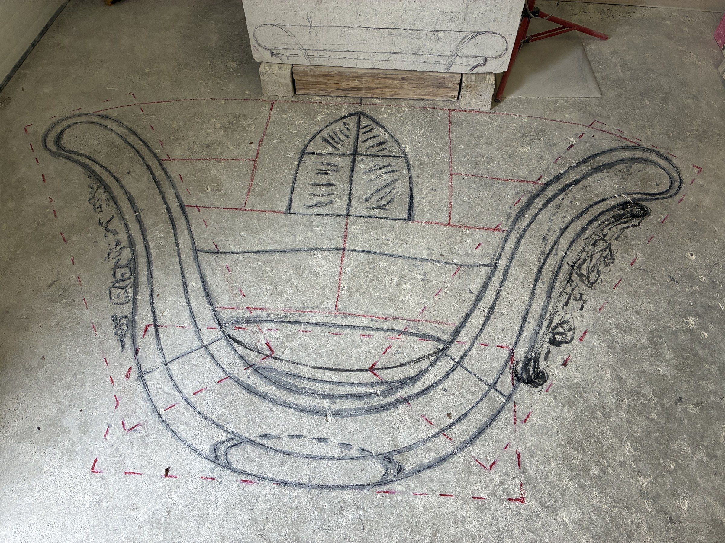 The full-scale template drawn on the workshop floor by November 3, 2025, showing the monument's complete outline with its two curved wings and central cartouche.