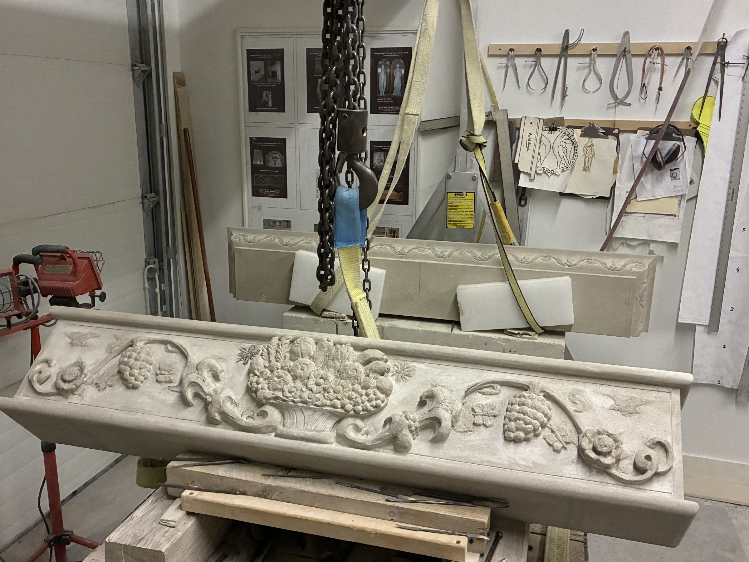 September 2025: the finished frieze raised on a chain hoist in the studio.