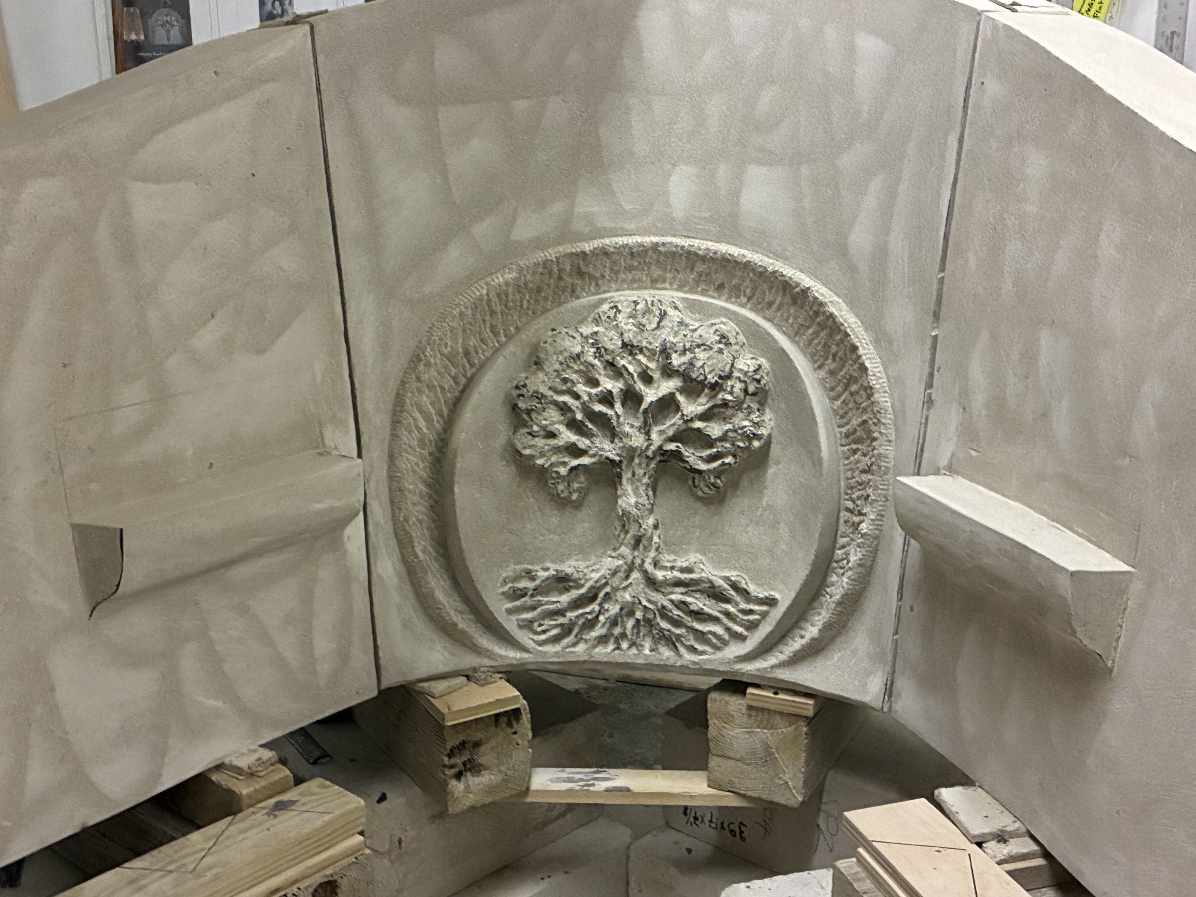 Close-up of the Tree of Life medallion in August 2026 — roots, trunk, branches and foliage enclosed within an oval ring, the oldest emblem of memory and renewal, placed just beneath the words “In God We Trust”.