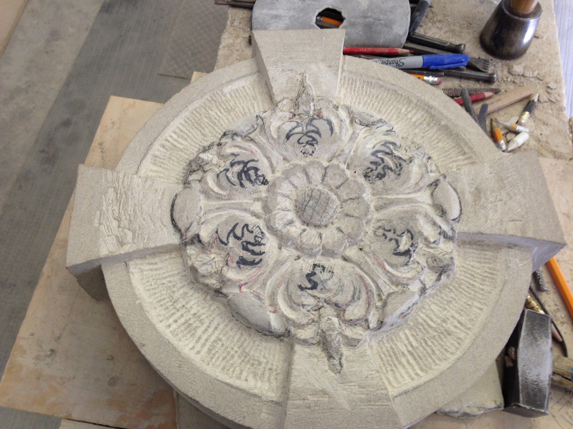 A rosette at an early stage, the flower blocked out and its leaves drawn in marker.