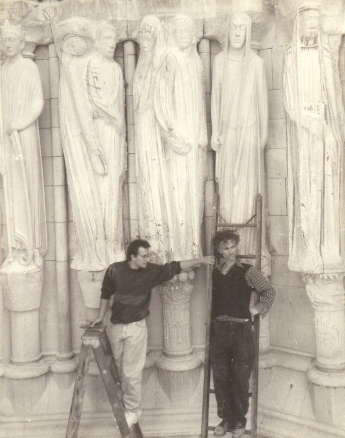 The sculptors at work beside the finished and in-progress statues of the Portal of Paradise.