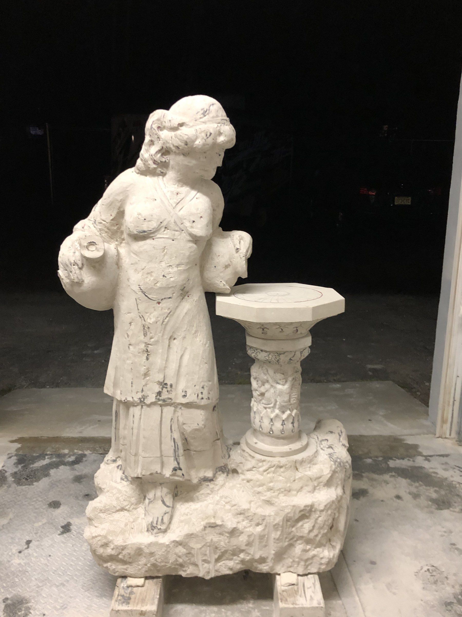 The figure and column at an earlier stage, lit at night in the open studio door.