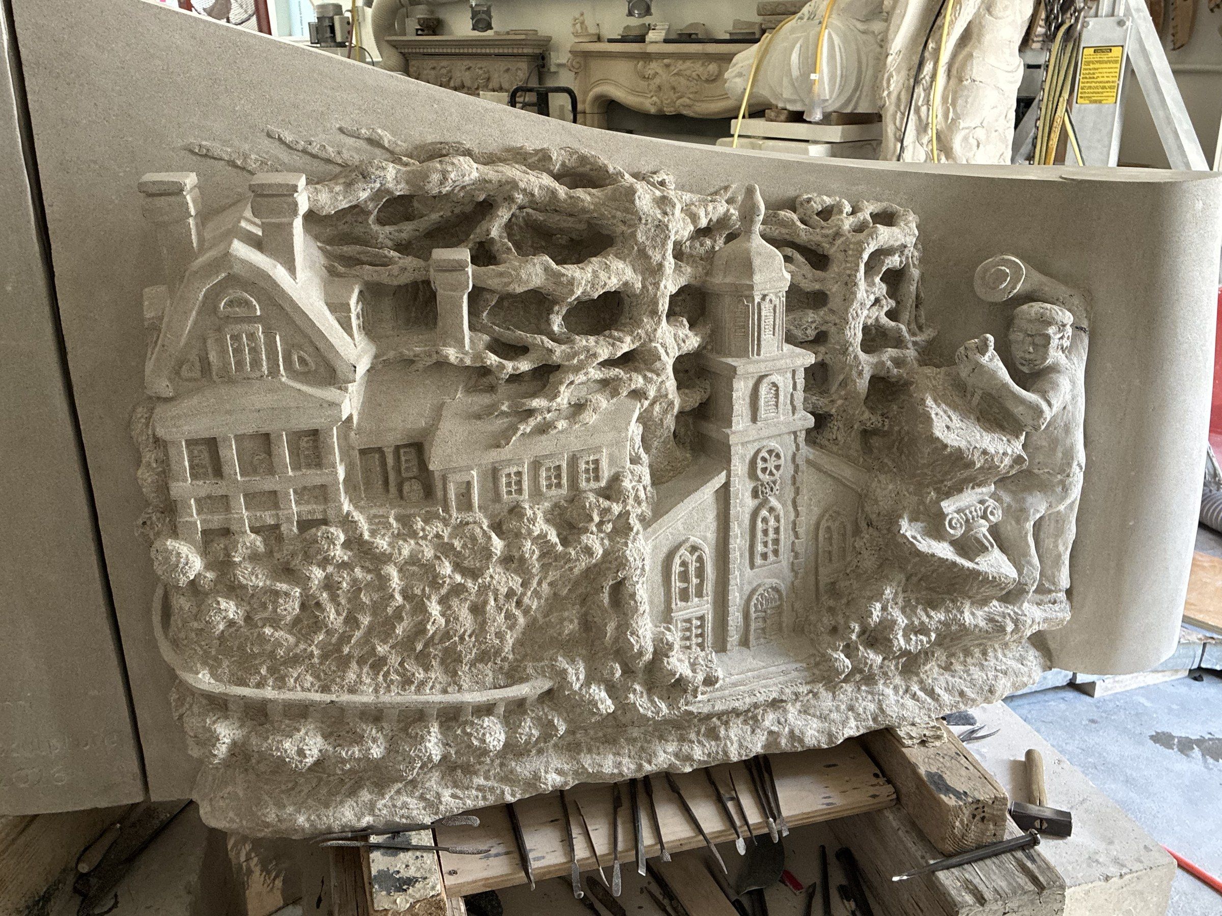 The Wyckoff face finished in the studio in October 2026: the Zabriskie House, the Wyckoff Reformed Church, the gnarled tree and the sculptor's bearded figure in high relief across the curved panel.